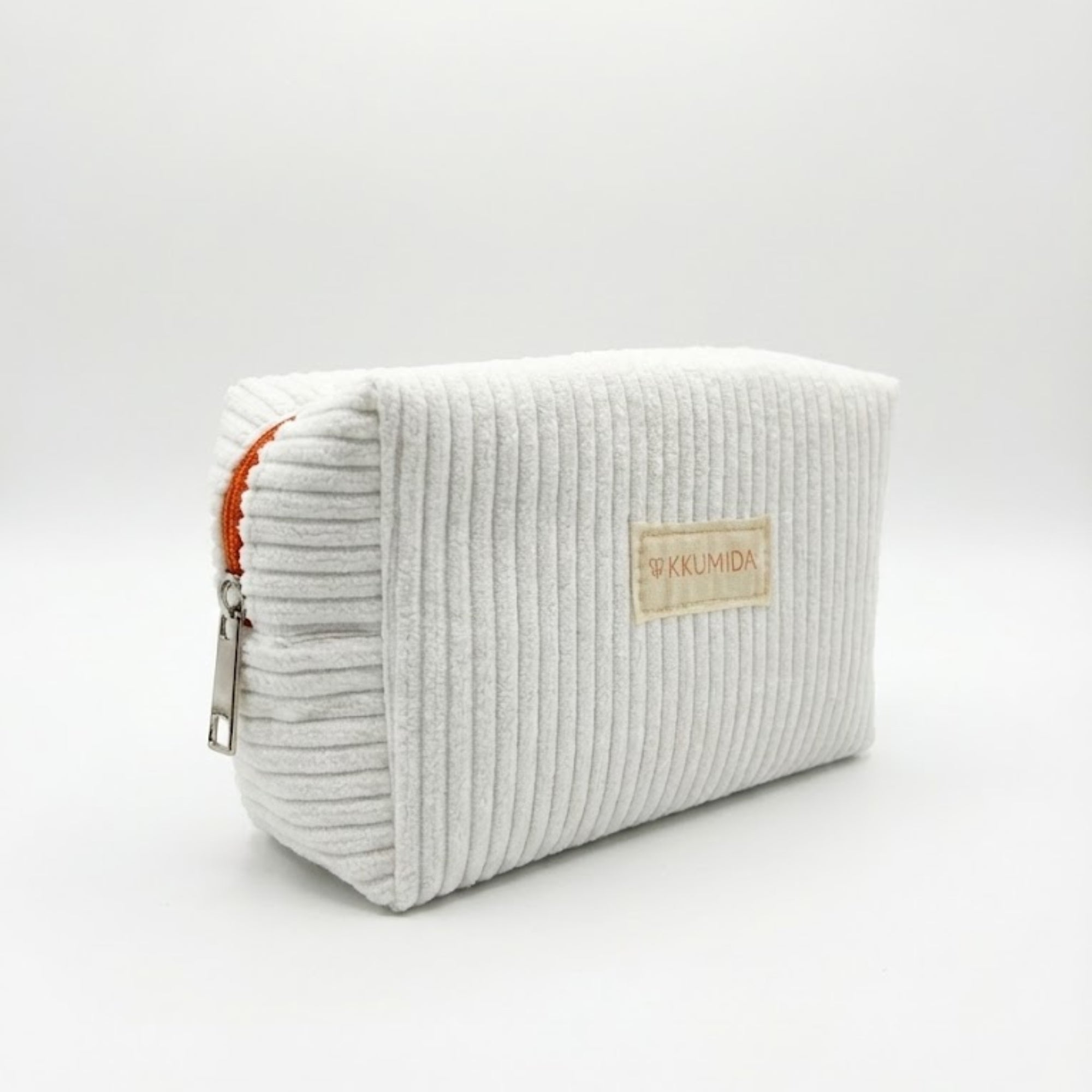 White ribbed rectangular pouch with a visible brand label on a light gray background