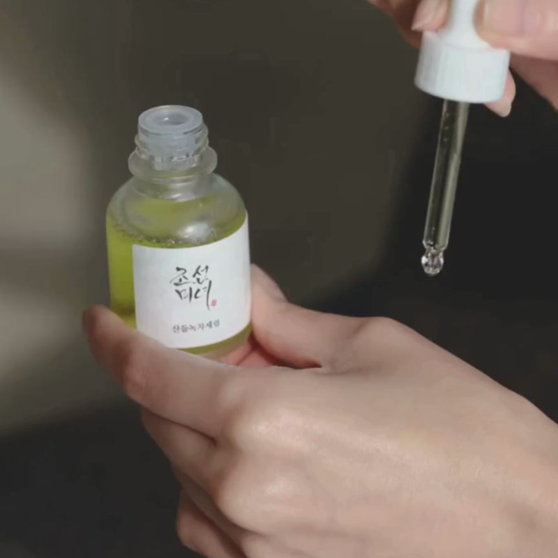 dropping beauty of joseon calming serum greentea on a hand